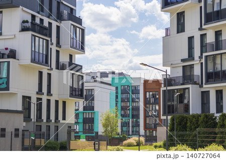 Modern apartment building facades with green and dark grey color blocks under sunny blue sky. Urban Modern apartment building facades with green and dark grey color blocks under sunny blue sky. Urban 140727064