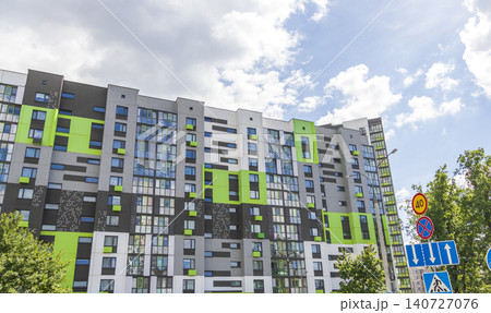 Modern apartment building facades with green and dark grey color blocks under sunny blue sky. Urban 140727076