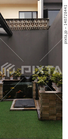Modern home yard with ornamental plants and decorative fish pond. Modern home yard with ornamental plants and decorative fish pond. 140728441