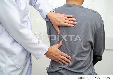 Physical therapy, Asian therapist doctor treat perform pain young man in hospital. Physical therapy, Asian therapist doctor treat perform pain young man in hospital. 140728889