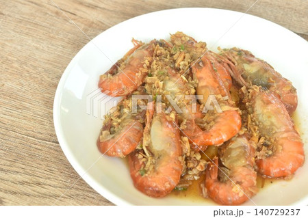 deep fried salty river shrimp with chop garlic and chili pepper arranging on plate deep fried salty river shrimp with chop garlic and chili pepper arranging on plate 140729237