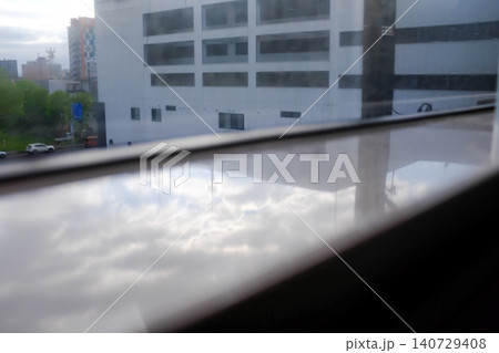 Looking from the train windows with sunlight. Reflection from the light. Heading to Sapporo, Hokkaido, Japan. Travel and nature concept. 140729408