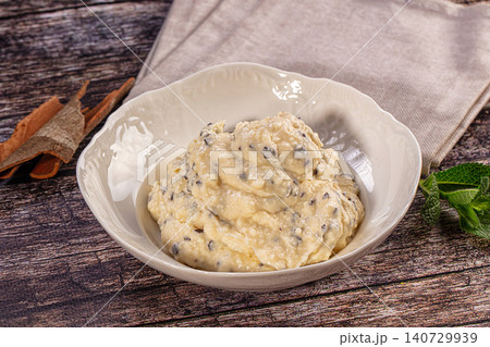 Creamy ricotta dessert with chocolate chips, cinnamon, and mint on rustic wood table Creamy ricotta dessert with chocolate chips, cinnamon, and mint on rustic wood table 140729939