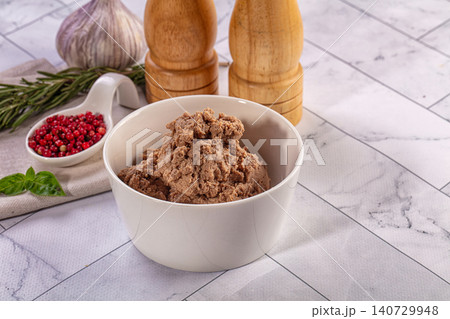 Homemade liver pate in white bowl with fresh herbs and spices on marble background Homemade liver pate in white bowl with fresh herbs and spices on marble background 140729948