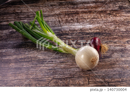 Fresh green onions white and red onions on rustic wooden background Fresh green onions white and red onions on rustic wooden background 140730004