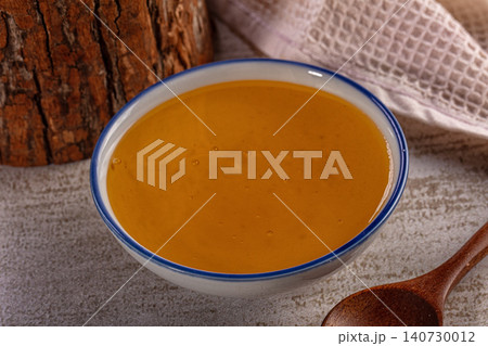 Bowl of honey with wooden spoon and rustic background Bowl of honey with wooden spoon and rustic background 140730012