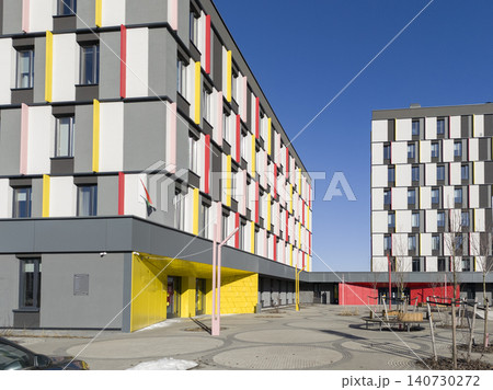 Colorful modern public building with geometric facade and bright accents. School kindergarten clinic architecture with playful design elements. Concept of municipal construction community Colorful modern public building with geometric facade and bright accents. School kindergarten clinic architecture with playful design elements. Concept of municipal construction community 140730272