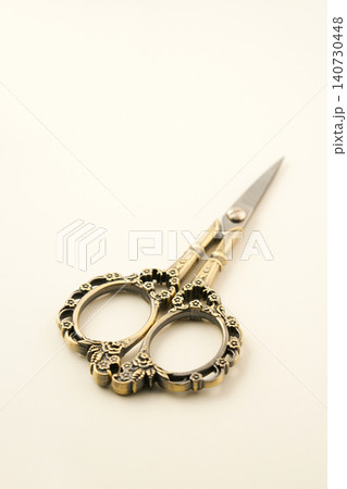 Small antique scissors on a simple background. 140730448