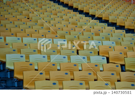 Empty chairs in the stadium. Empty seats in the stadium. Sport background pattern photo. Patterns of chairs in a theater. Seats background pattern photo.  140730581