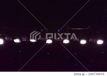 Set of professional stage lighting equipment on the stage for gig illumination of theater or concert hall. Stage lights, spotlights and laser beams. Rays of light from the floodlights. Concert light. Set of professional stage lighting equipment on the stage for gig illumination of theater or concert hall. Stage lights, spotlights and laser beams. Rays of light from the floodlights. Concert light. 140730610