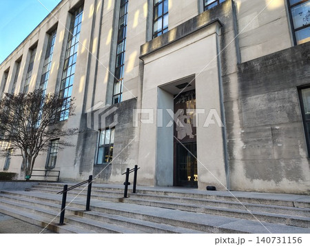 The facade and front entrance of a monumental administrative building designed in the strict architectural styles of modernism and classicism 140731156
