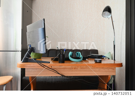 Modern empty freelancer or student work table with laptop, wireless headphones and documents in folders at home 140732051