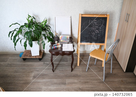 Art supplies are arranged on a wooden desk with paper, paints, and brushes in a creative workspace Art supplies are arranged on a wooden desk with paper, paints, and brushes in a creative workspace 140732065