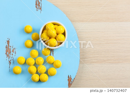 Tasty lemon drops on wooden table, flat lay. Space for text 140732407