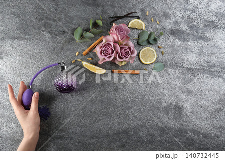 Woman with perfume. Fragrance composition, flowers and lemon on grey background, top view. Space for text Woman with perfume. Fragrance composition, flowers and lemon on grey background, top view. Space for text 140732445