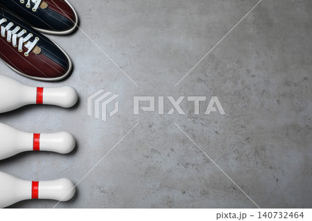Bowling shoes and pins on grey stone table, flat lay. Space for text Bowling shoes and pins on grey stone table, flat lay. Space for text 140732464