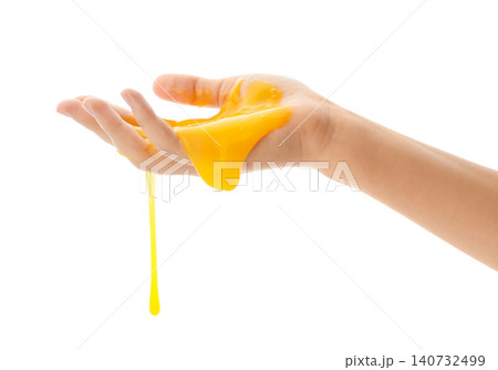 Woman playing with yellow slime isolated on white, closeup. Antistress toy Woman playing with yellow slime isolated on white, closeup. Antistress toy 140732499