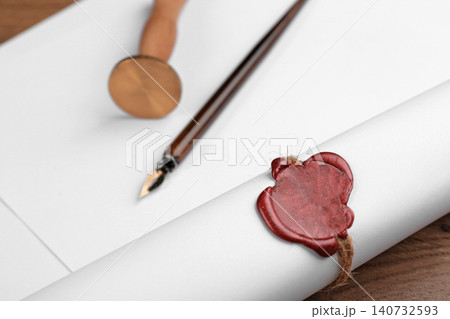 Document with notary's wax stamp on wooden table, closeup Document with notary's wax stamp on wooden table, closeup 140732593