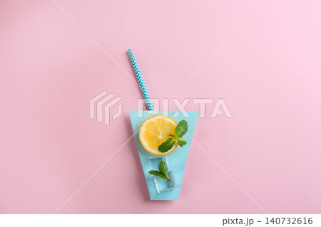 Creative lemonade layout with lemon slice, mint and ice cubes on pink background, top view Creative lemonade layout with lemon slice, mint and ice cubes on pink background, top view 140732616