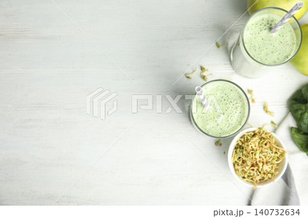 Flat lay composition with green buckwheat smoothie on white wooden table, space for text Flat lay composition with green buckwheat smoothie on white wooden table, space for text 140732634