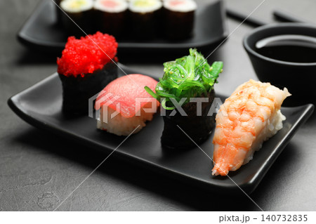 Set of delicious sushi on grey table Set of delicious sushi on grey table 140732835