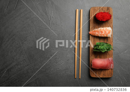 Set of delicious sushi on grey table, flat lay. Space for text 140732836