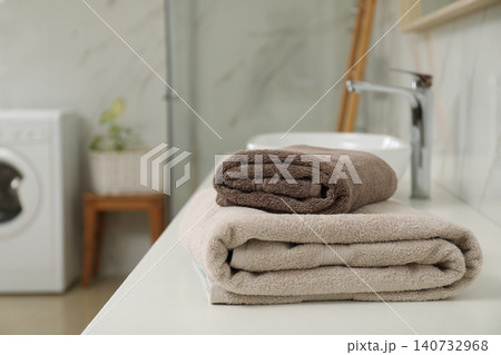 Stack of clean towels on bathroom countertop Stack of clean towels on bathroom countertop 140732968