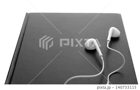 Bible and earphones on white background, closeup. Religious audiobook 140733115