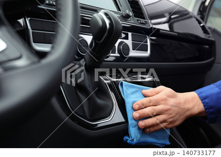 Car wash worker cleaning automobile interior, closeup Car wash worker cleaning automobile interior, closeup 140733177