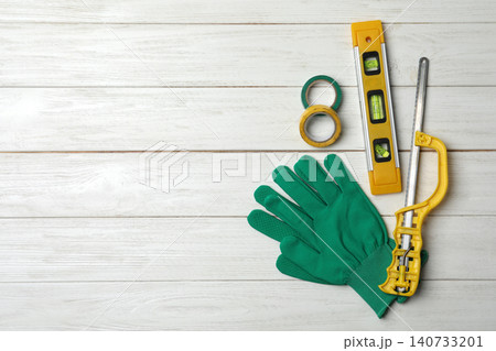 Flat lay composition with carpenter's tools on white wooden background. Space for text Flat lay composition with carpenter's tools on white wooden background. Space for text 140733201