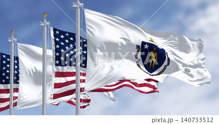 The flags of Massachusetts and the United States waving in the wind on a clear day The flags of Massachusetts and the United States waving in the wind on a clear day 140733512