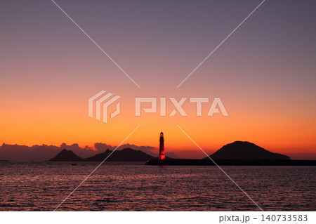 Seascape at sunshine. Lighthouse and sailings on the coast. Seaside town of Turgutreis and spectacular sunshine Seascape at sunshine. Lighthouse and sailings on the coast. Seaside town of Turgutreis and spectacular sunshine 140733583
