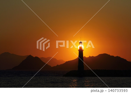 Seascape at sunshine. Lighthouse and sailings on the coast. Seaside town of Turgutreis and spectacular sunshine 140733593