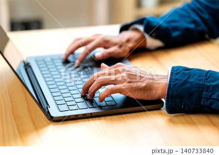 Close up hands of business man type the keyboard of laptop on table during work in the office with concept of business technology support the success of the company. 140733840