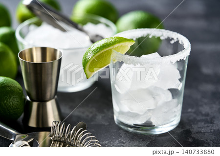 Bar accessories and ingredients for prepared cocktail Margarita on a black table. Bar accessories and ingredients for prepared cocktail Margarita on a black table. 140733880