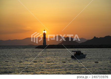 Seascape at sunshine. Lighthouse and sailings on the coast. Seaside town of Turgutreis and spectacular sunshine 140733976