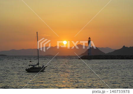 Seascape at sunshine. Lighthouse and sailings on the coast. Seaside town of Turgutreis and spectacular sunshine 140733978