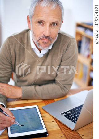 Portrait, laptop and businessman with tablet in office for statistics research on internet. Serious, computer and mature financial planner work on budget project with digital technology in workplace. Portrait, laptop and businessman with tablet in office for statistics research on internet. Serious, computer and mature financial planner work on budget project with digital technology in workplace. 140734308