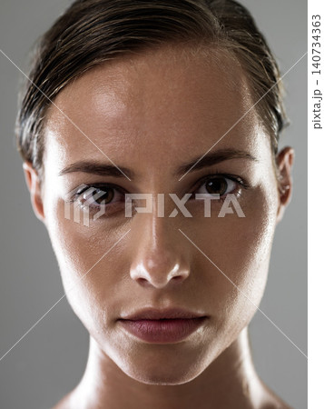 Woman, serious face and confidence for fitness, strong and determined with sweat from workout on grey background. Headshot, portrait and athlete for sports, exercise with pride and power in studio Woman, serious face and confidence for fitness, strong and determined with sweat from workout on grey background. Headshot, portrait and athlete for sports, exercise with pride and power in studio 140734363