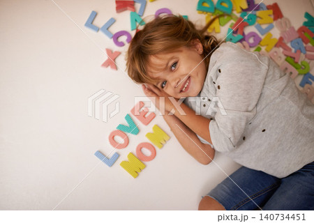 Girl, letter toys and love mom with English and learning for development, games and smile in playroom at family home. Portrait, education and growth in childhood with alphabet, language and happiness 140734451