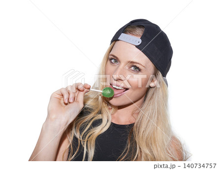 Portrait, fashion and woman with lollipop in studio with stylish or trendy cap isolated on a white background. Face, lick candy and young blonde model with sweets, food or eating sugar on a backdrop Portrait, fashion and woman with lollipop in studio with stylish or trendy cap isolated on a white background. Face, lick candy and young blonde model with sweets, food or eating sugar on a backdrop 140734757