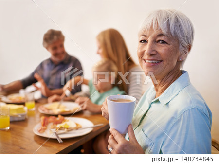 Grandmother, family and smile for breakfast with happiness in morning for bonding with conversation, support and care. Portrait, senior woman and meal to eat with coffee at table, enjoy and together Grandmother, family and smile for breakfast with happiness in morning for bonding with conversation, support and care. Portrait, senior woman and meal to eat with coffee at table, enjoy and together 140734845
