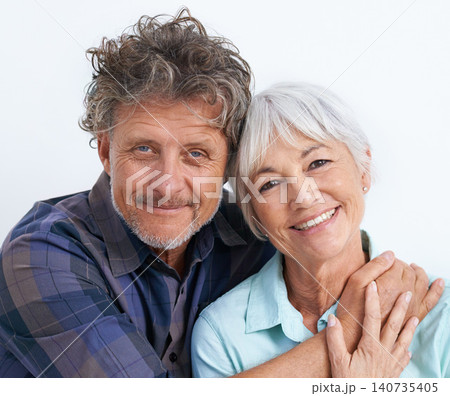 Old couple, face and hug with happiness in studio, love and security with comfort for bonding. Marriage partner, retirement and smile in portrait, people with trust and loyalty on white background 140735405