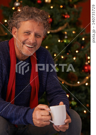 Happy man, portrait and Christmas tree with coffee, mug or cup of tea for festive season or celebration at home. Face of senior or male person with smile for hot beverage, December holiday or weekend 140735729