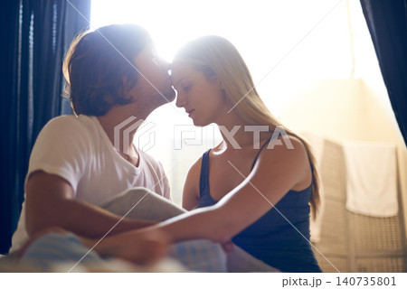 Forehead, kiss and couple in a house with love, commitment or bonding, trust or relax in their home together. Peace, gratitude and people embrace in a living room with support, security or respect Forehead, kiss and couple in a house with love, commitment or bonding, trust or relax in their home together. Peace, gratitude and people embrace in a living room with support, security or respect 140735801