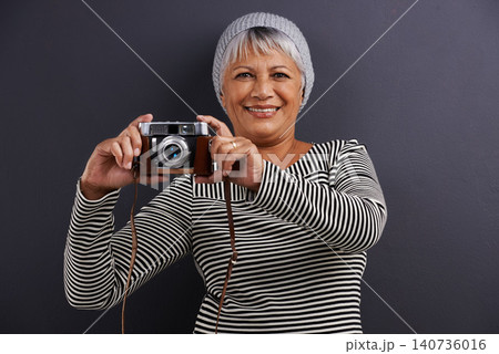 Portrait, camera and photography with senior woman, creative and artistic on a dark studio background. Face, model and mature lady with photographer and hipster style with confidence and freelancer Portrait, camera and photography with senior woman, creative and artistic on a dark studio background. Face, model and mature lady with photographer and hipster style with confidence and freelancer 140736016
