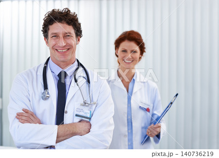 Doctors, man and woman with arms crossed in portrait for team, partnership or smile with pride for healthcare. Medic employees, people and happy with collaboration for wellness, services and clinic 140736219