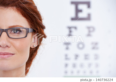 Woman, glasses and eye chart or vision consultation or prescription lens for eyewear health, examination or checkup. Female person, frame and optical test or wellness or letters, diagnosis or reading 140736224