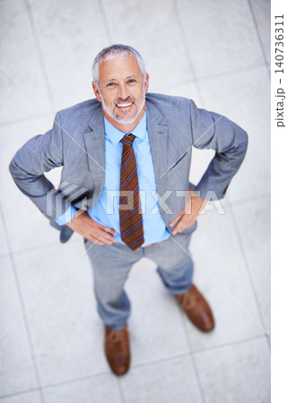 Happy, portrait and high angle of man in business or office with professional confidence and pride. Above, entrepreneur and mature person smile in lobby excited for morning in London at workplace Happy, portrait and high angle of man in business or office with professional confidence and pride. Above, entrepreneur and mature person smile in lobby excited for morning in London at workplace 140736311