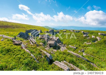 alpine grassy meadow. carpathian mountains landscape with huge boulders. alpine nature scenery of ukraine highlands in summer. view of remote place in mountains alpine grassy meadow. carpathian mountains landscape with huge boulders. alpine nature scenery of ukraine highlands in summer. view of remote place in mountains 140736419
